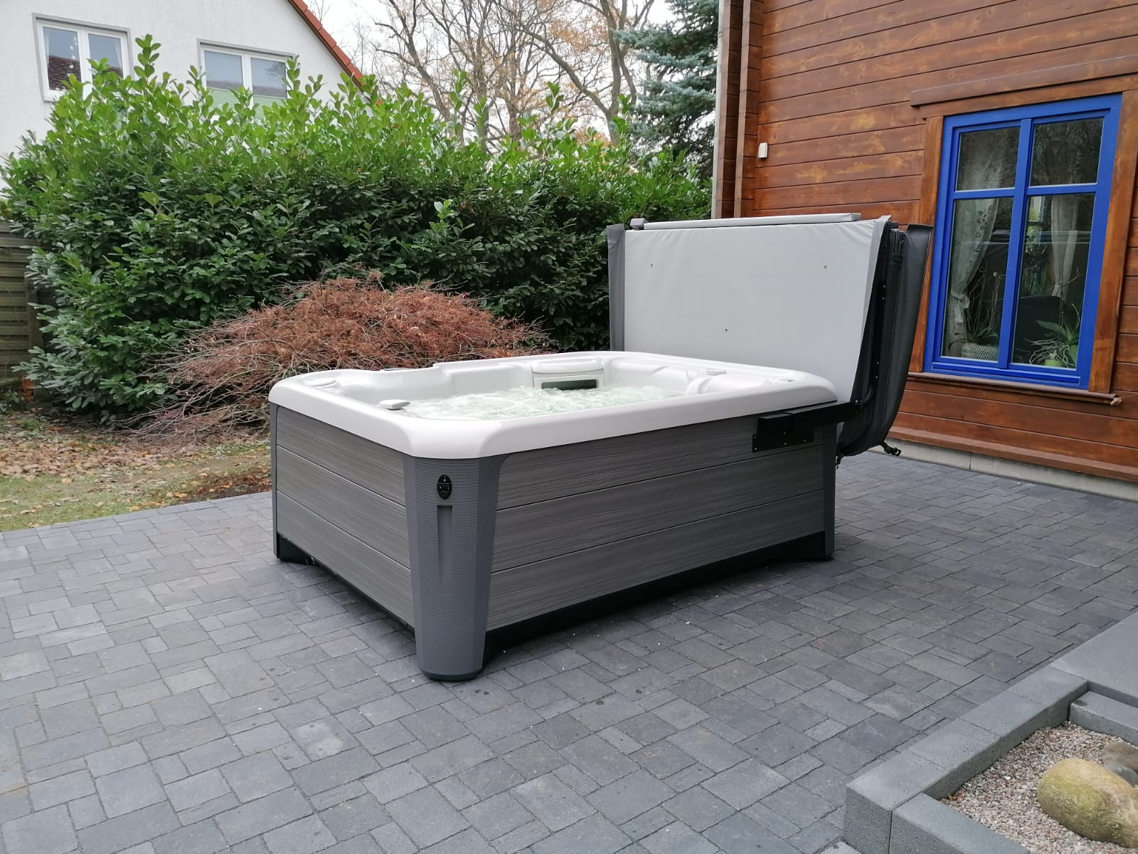 Ein Whirlpool auf einer Terrasse mit der Abdeckhilfe Lift'n Glide